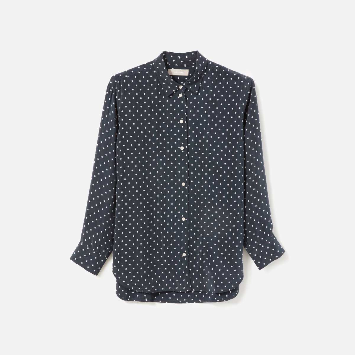 a navy button up shirt with white polka dots