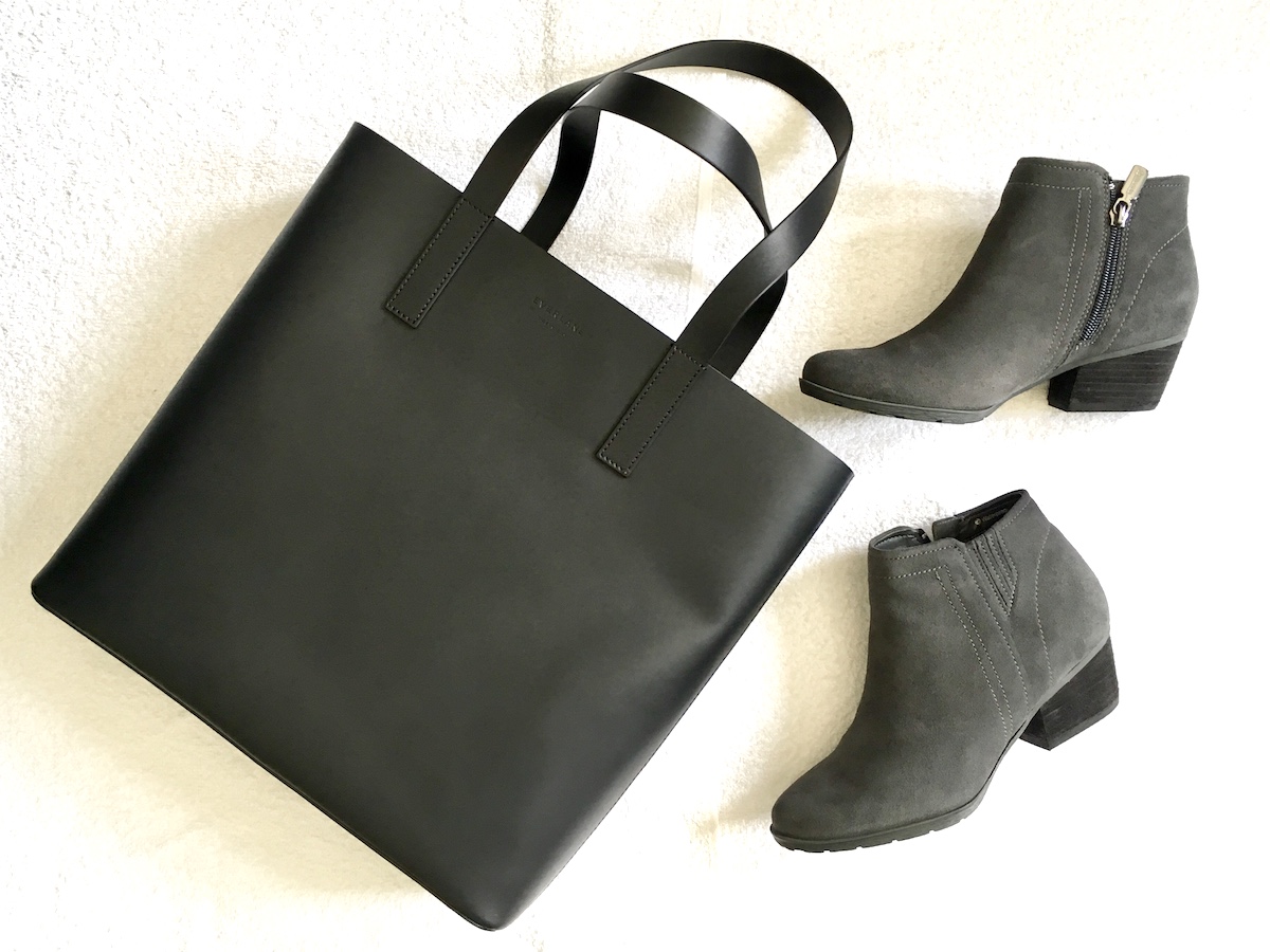 Everlane day square tote in black and gray Blondo ankle boots on a white background.