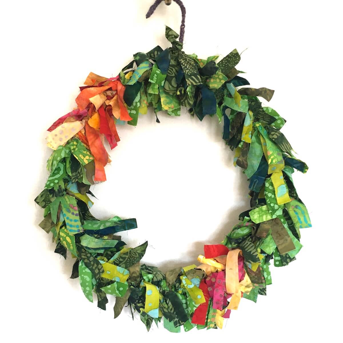 Why I don't do holiday gifts: A DIY wreath made out of fabric scraps.