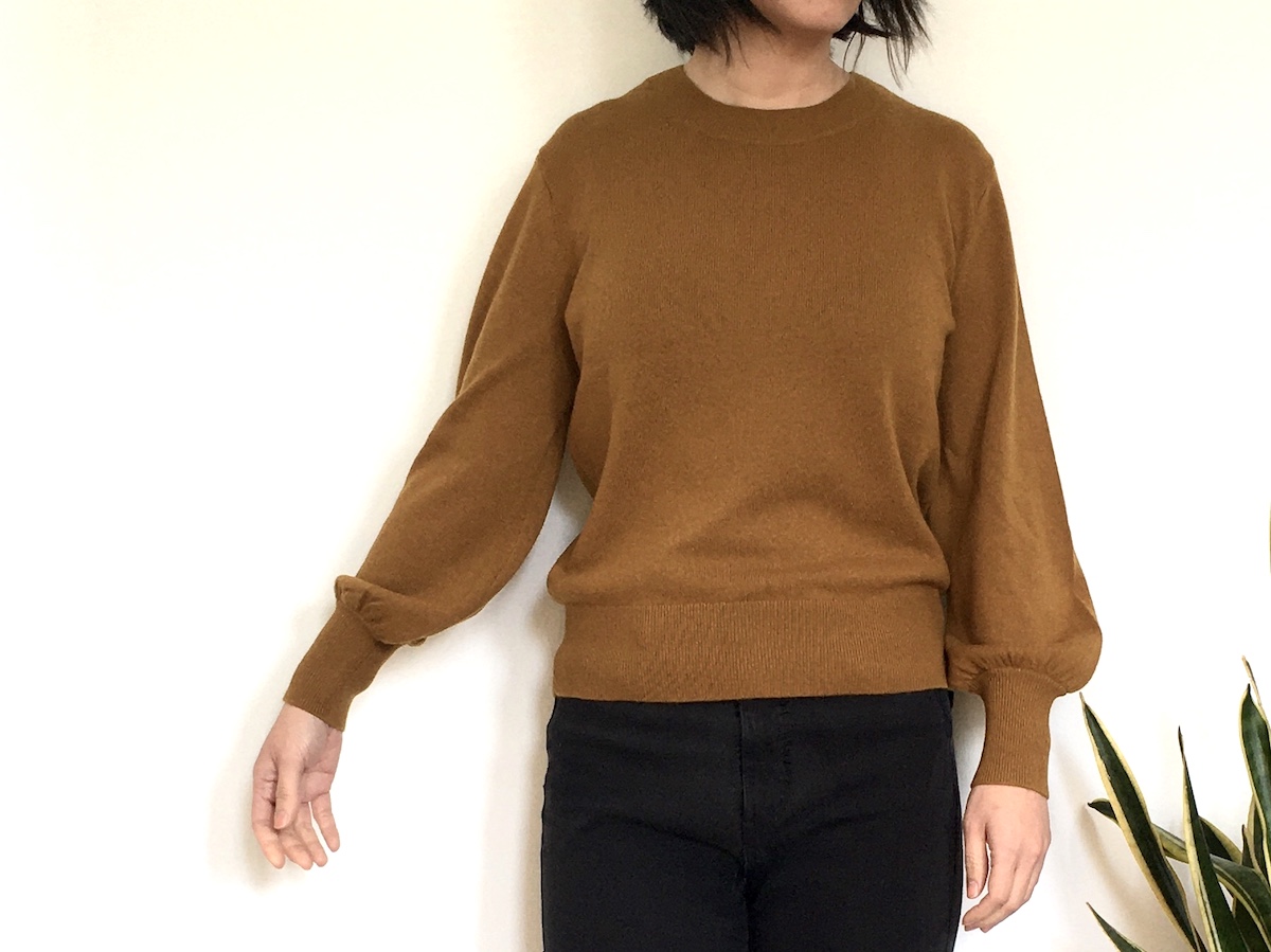 Everlane cashmere lantern sweater worn by a woman with dark hair.