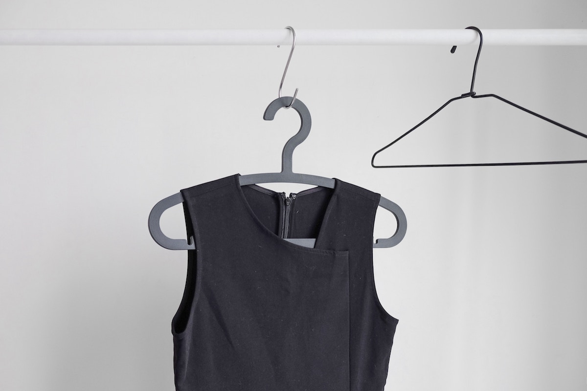 A black sleeveless garment on a hanger