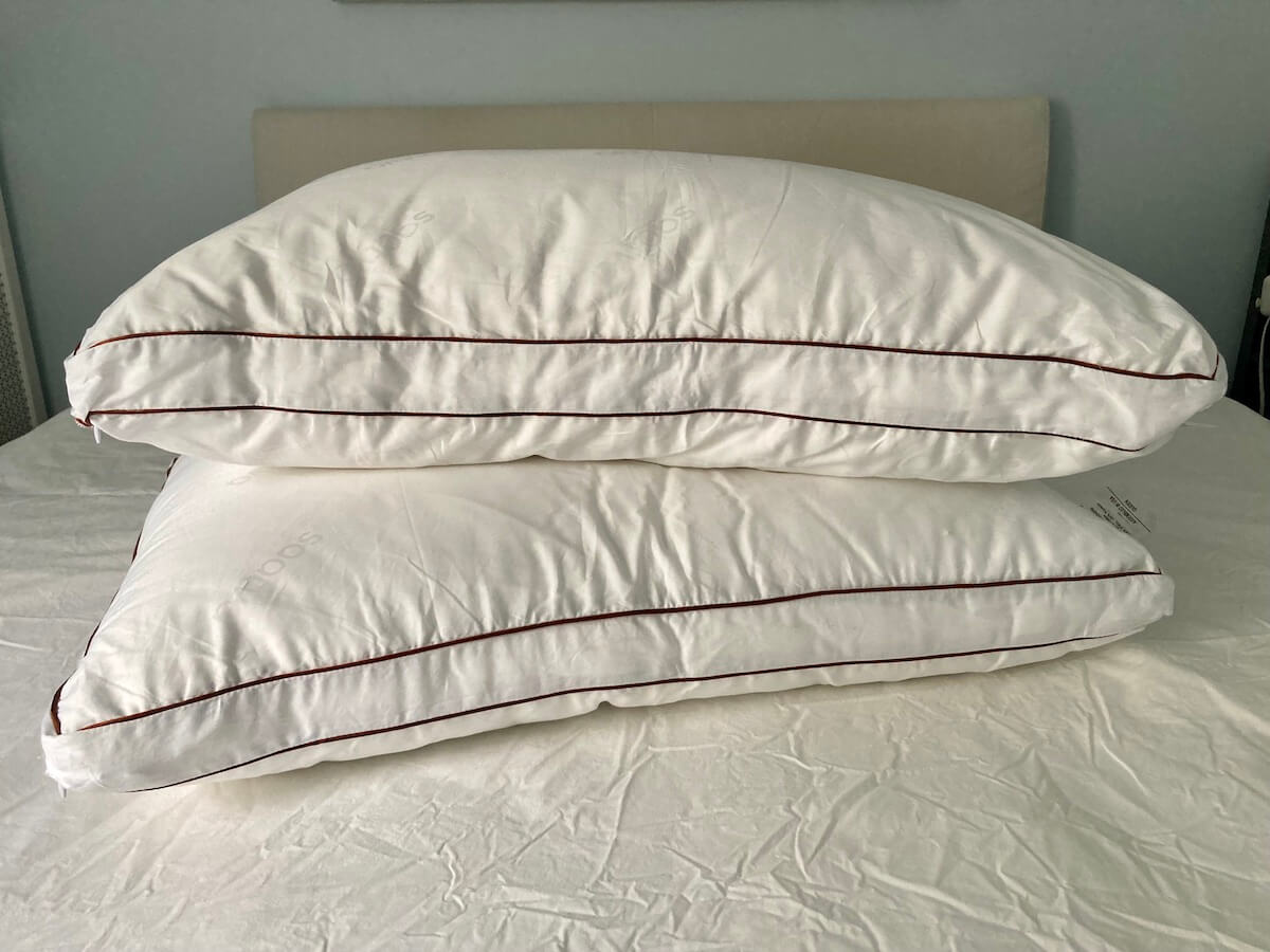 2 gusseted pillows on a bed