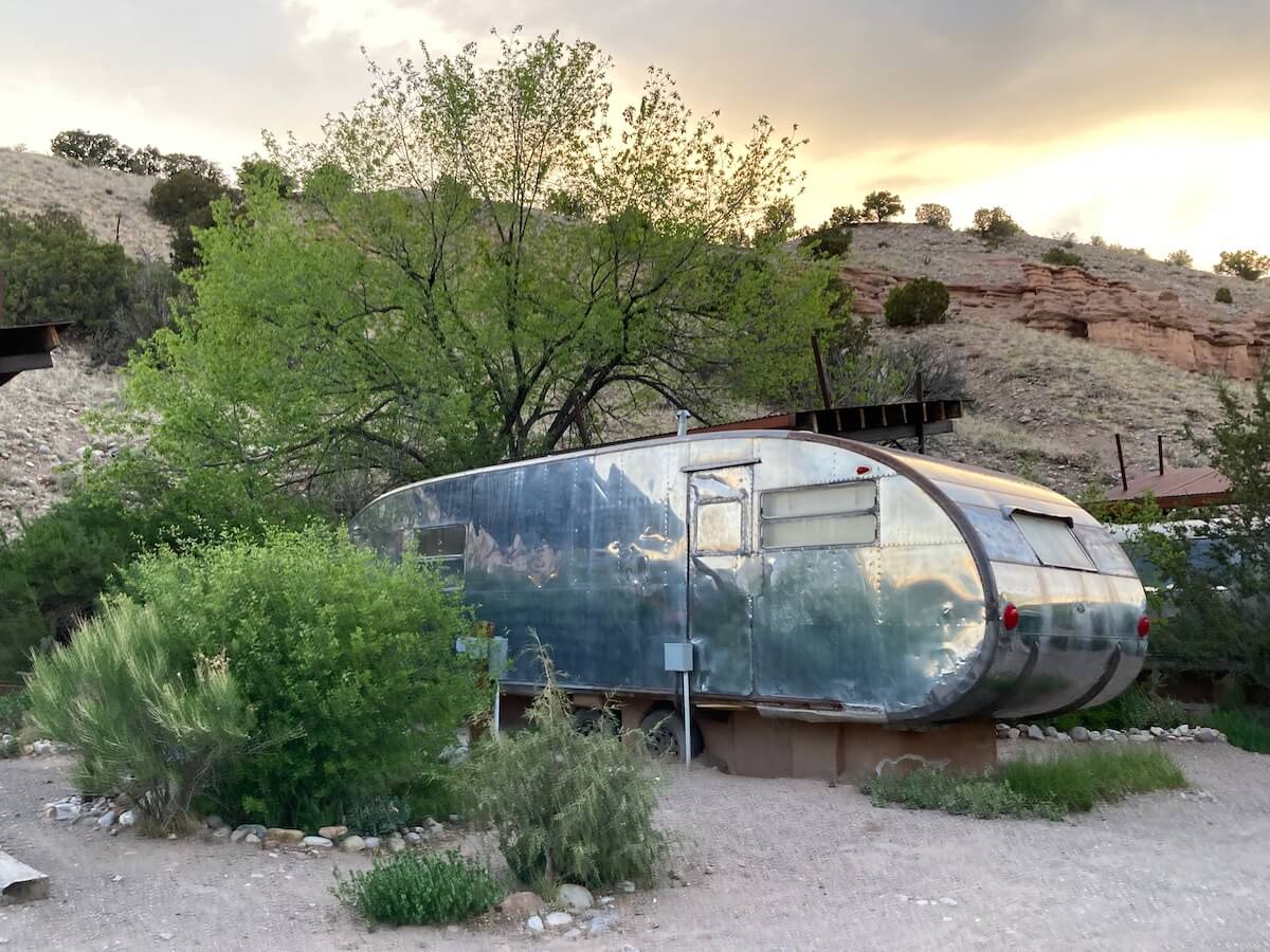 Ojo Caliente vintage trailer among the New Mexico landscape