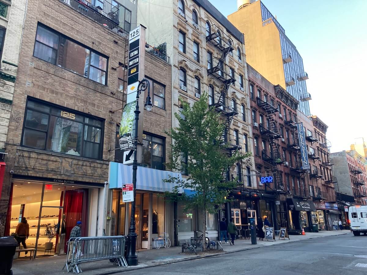 Brick buildings with fire escapes on a street in New York's Lowest Eastside